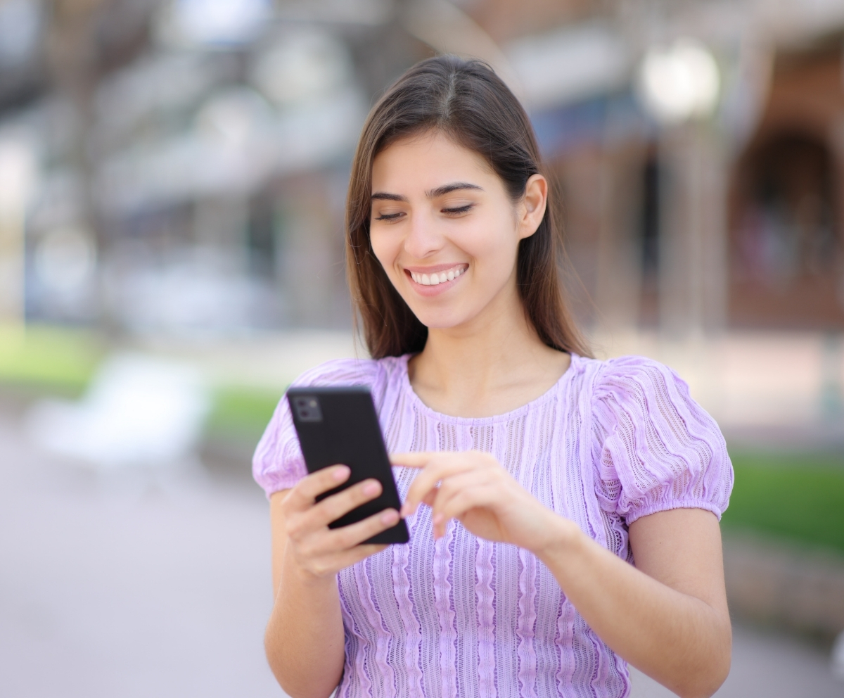 Woman using a smartphone to review Share Secured Loan options