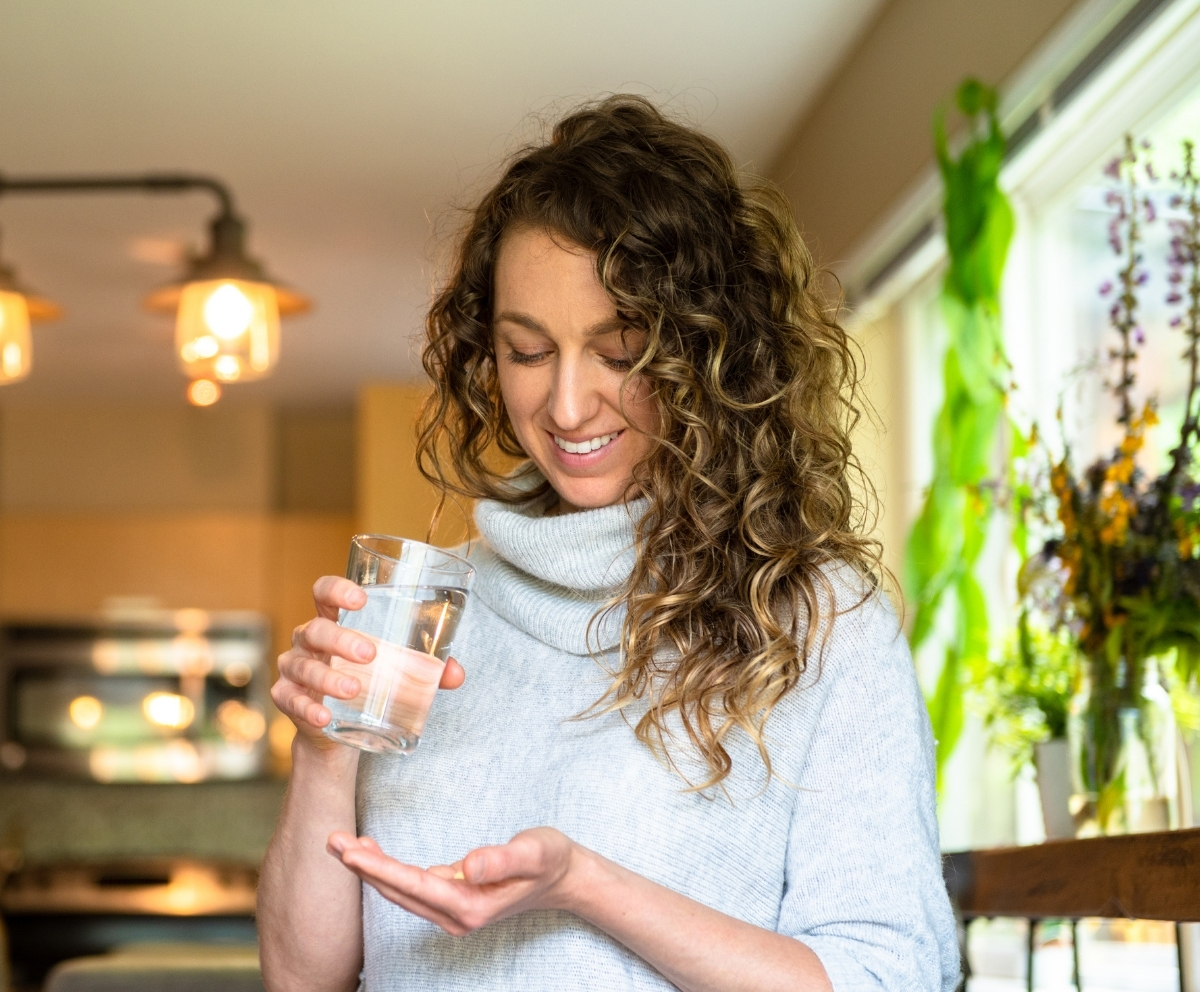 Woman taking medication during an illness that may affect loan payment ability