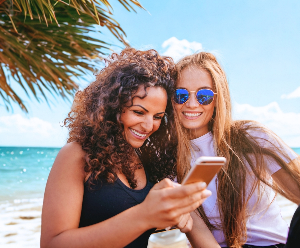 Friends using a smartphone while enjoying financial peace of mind