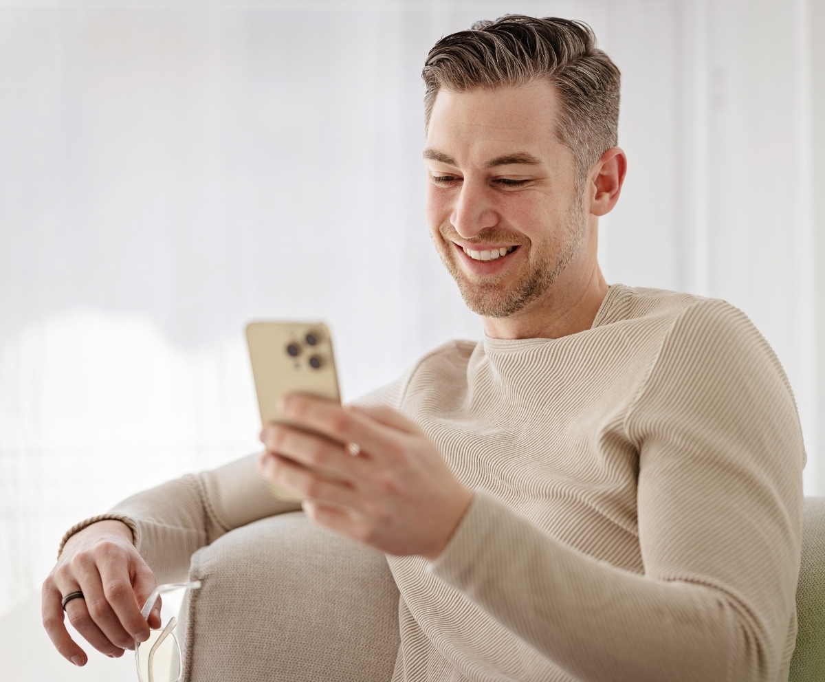 Man using mobile banking on a smartphone to manage a checking account