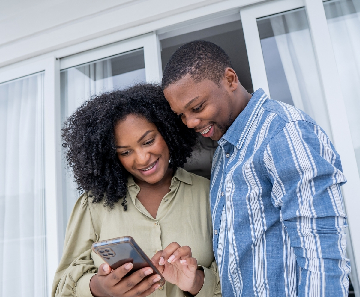 Couple using mobile banking to review checking account activity on a smartphone
