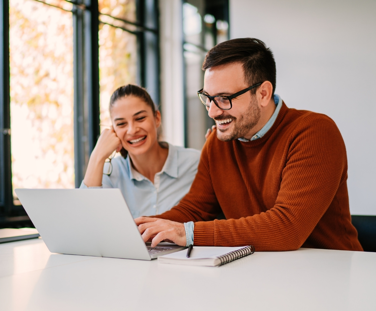 Couple using a laptop while reviewing IRA retirement savings options