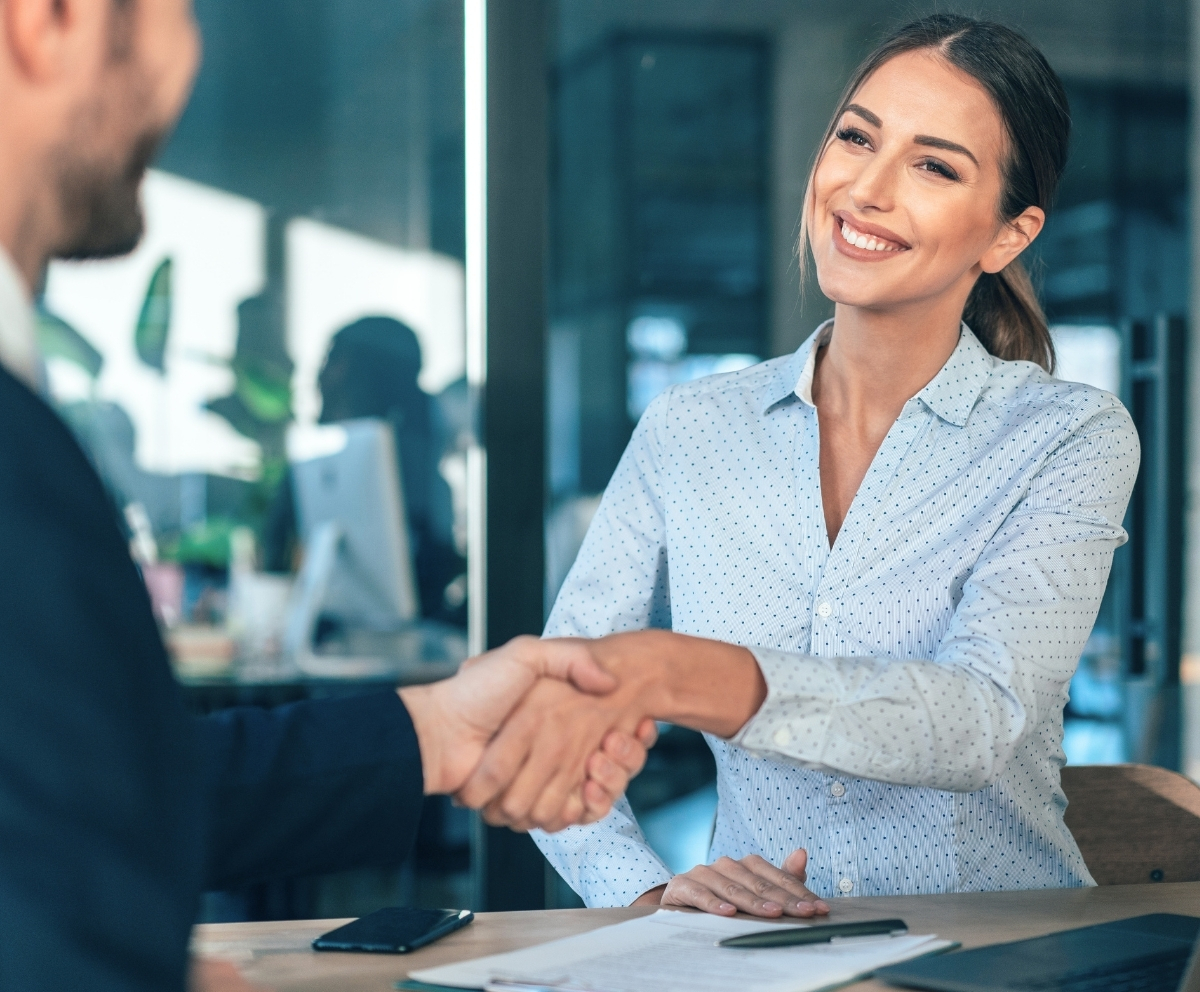 Woman shaking hands during a Connect Credit Union membership conversation