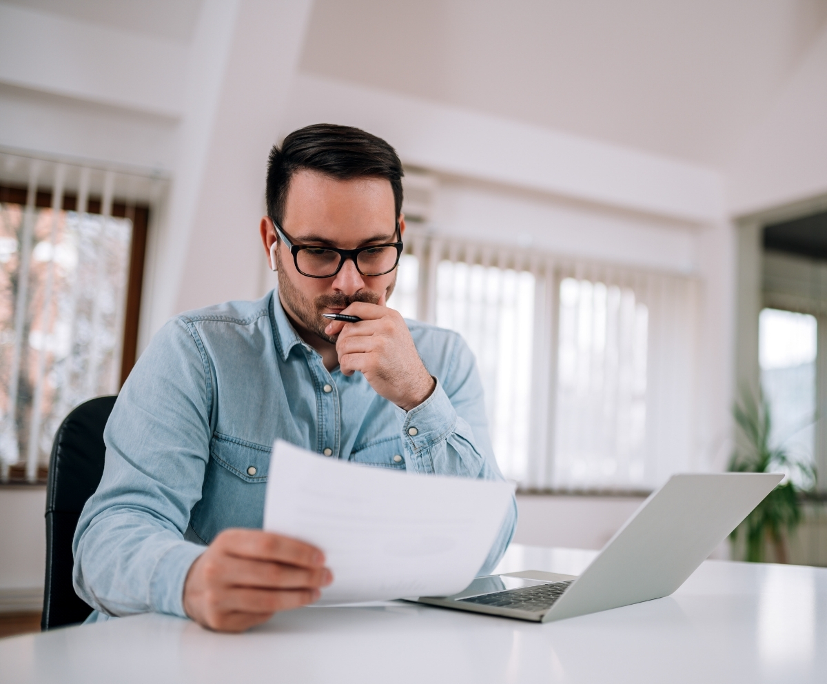 Man reviewing Money Market Account details and savings options at a laptop
