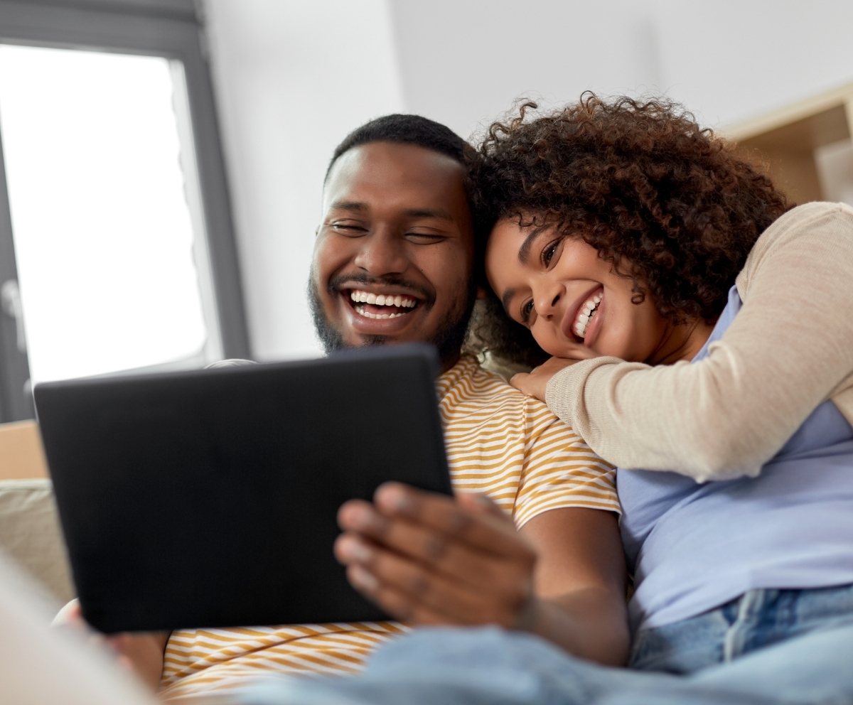 Couple using a tablet to review savings goals and Money Market Account options