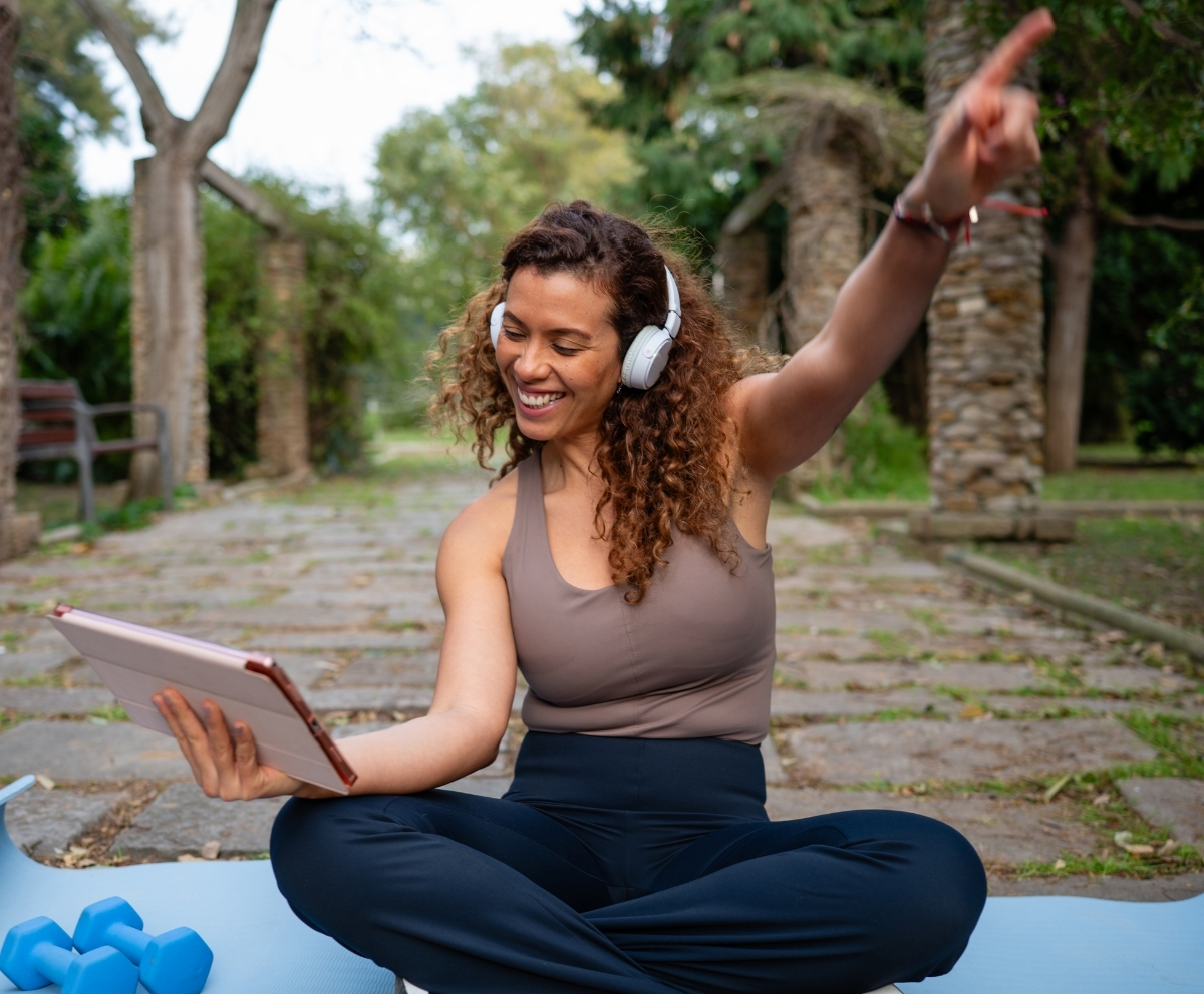 Woman using a tablet outdoors while managing savings with a Money Market Account